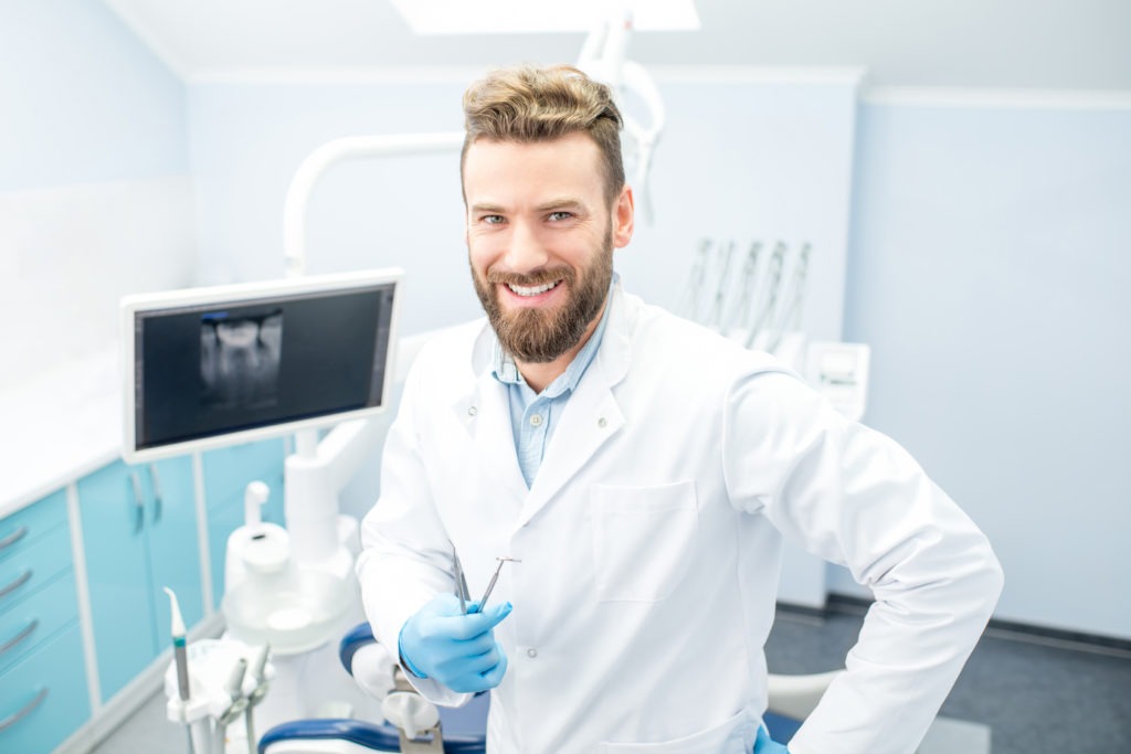 an image of a dentist standing in his treatment room.
