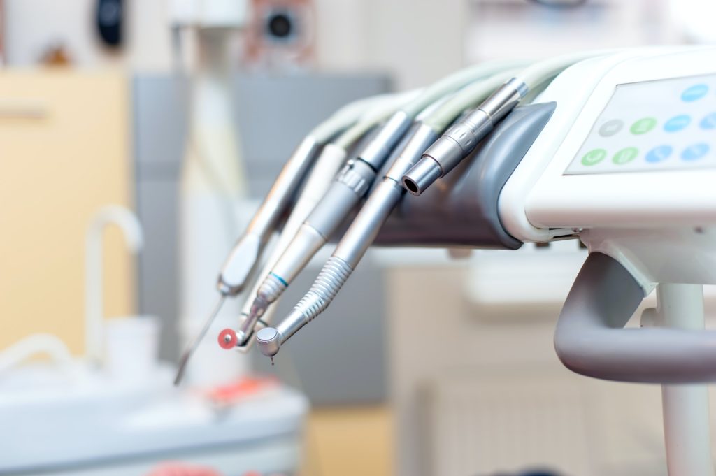 Dental tools on dentist chair with medical equipment and new technology