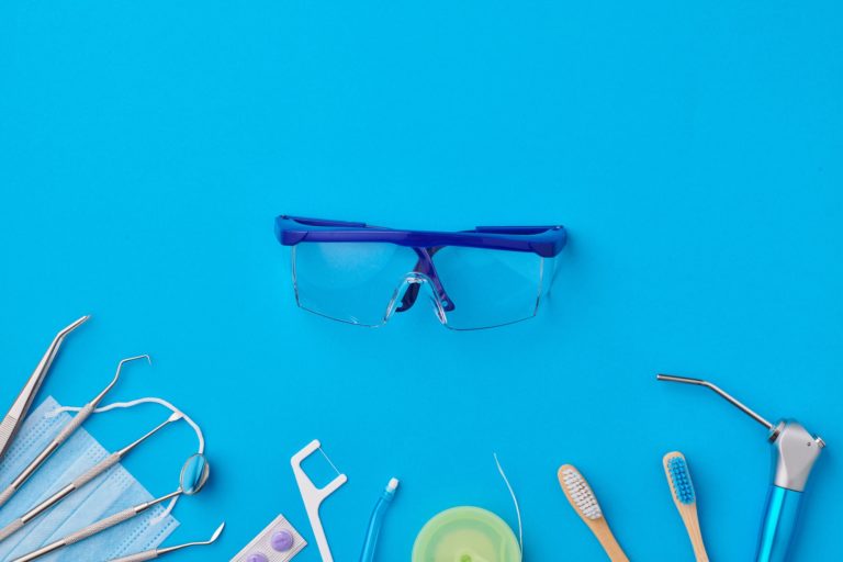 Dentist tools over blue background top view